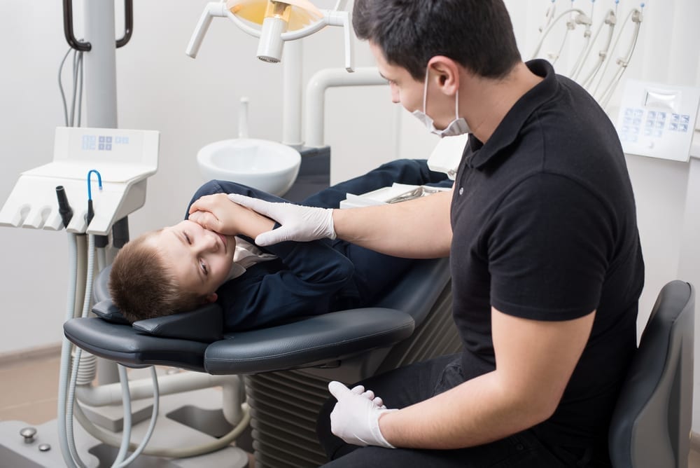 Boy who had dental emergency at a dental office