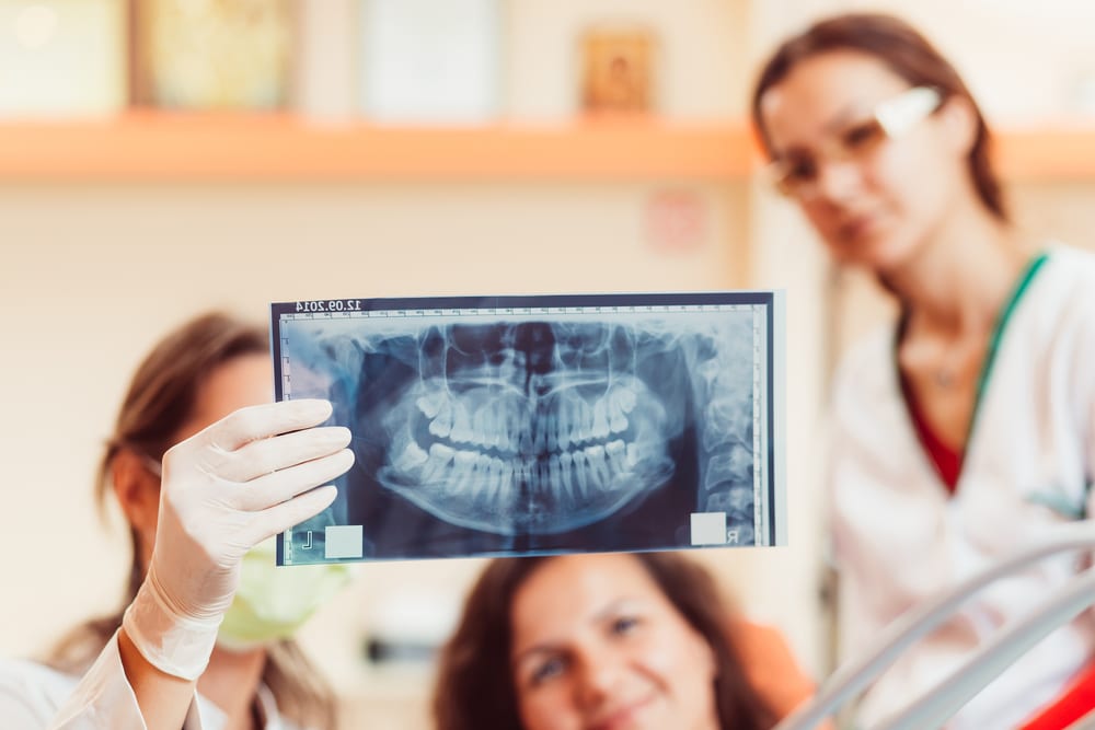 Dentist showing patient x-ray